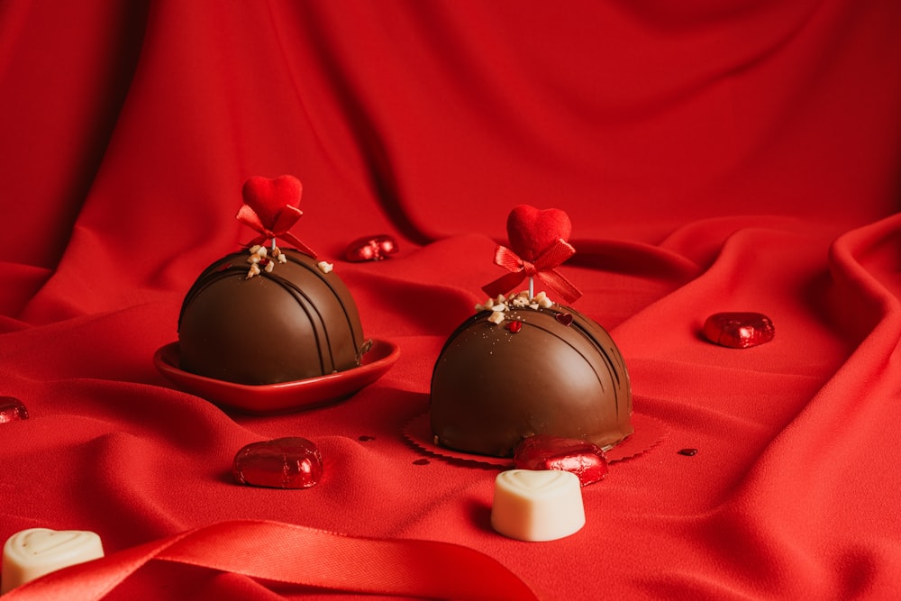 two pieces of chocolate sitting on top of a red cloth