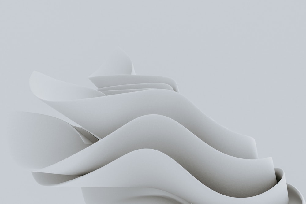 a white object with wavy shapes on a gray background