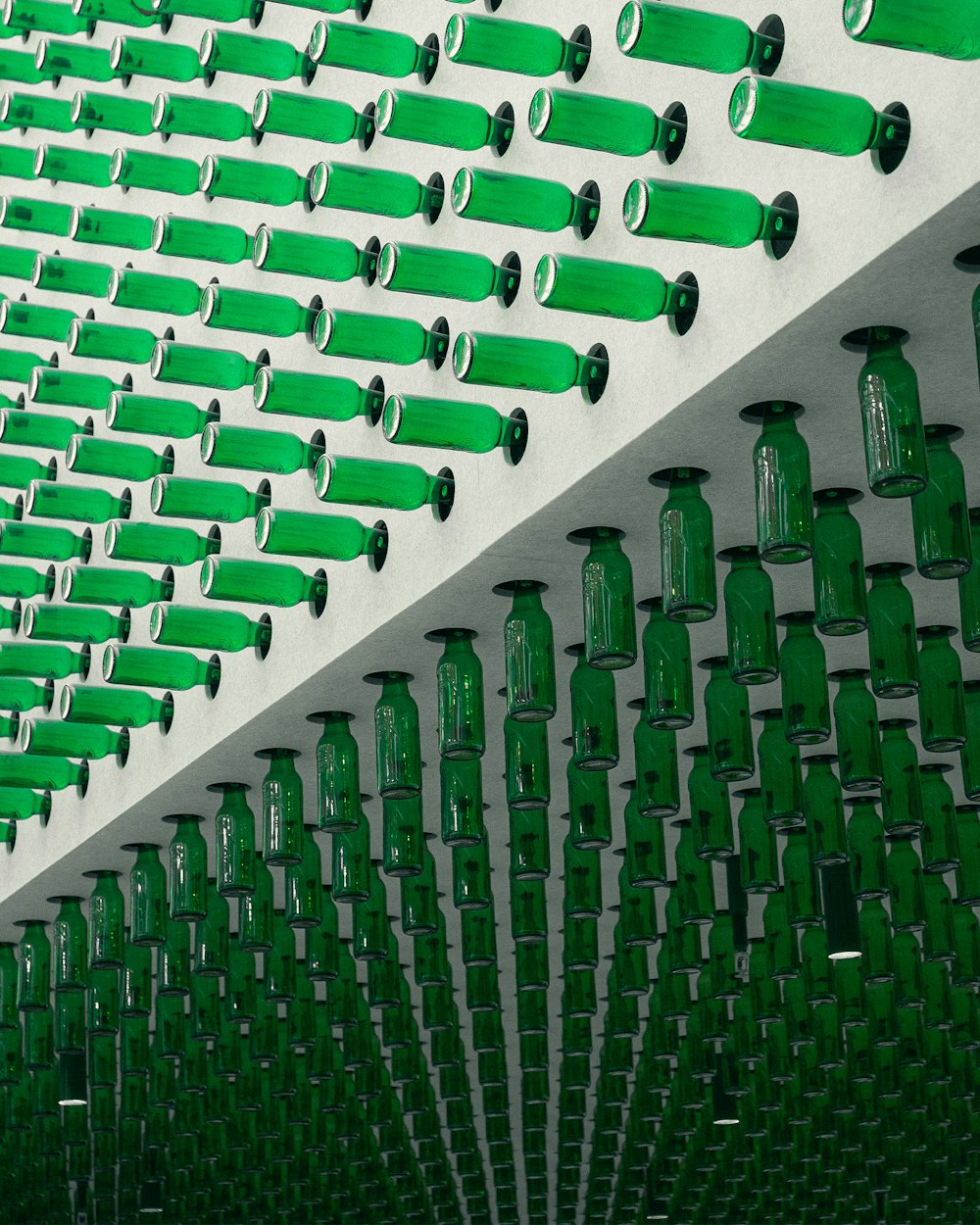 many green bottles are lined up on a wall