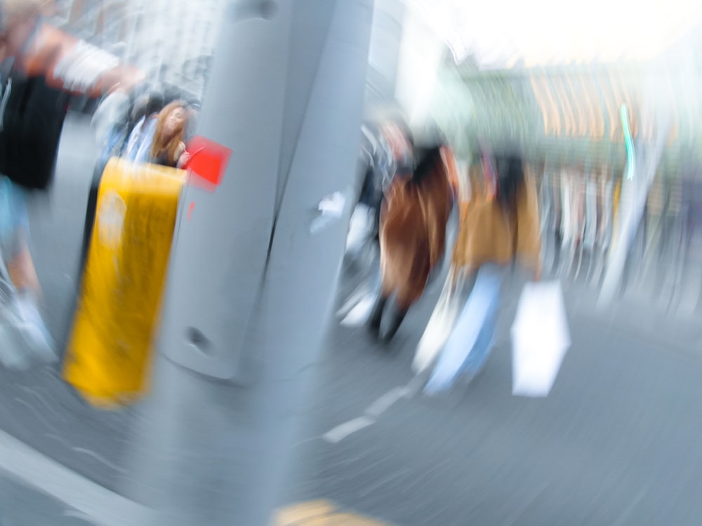 a blurry photo of people walking down a street