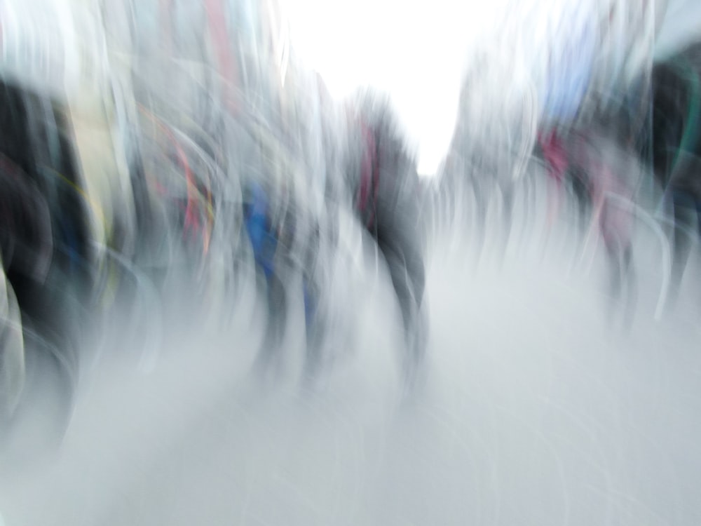 a blurry photo of a group of people walking down a street