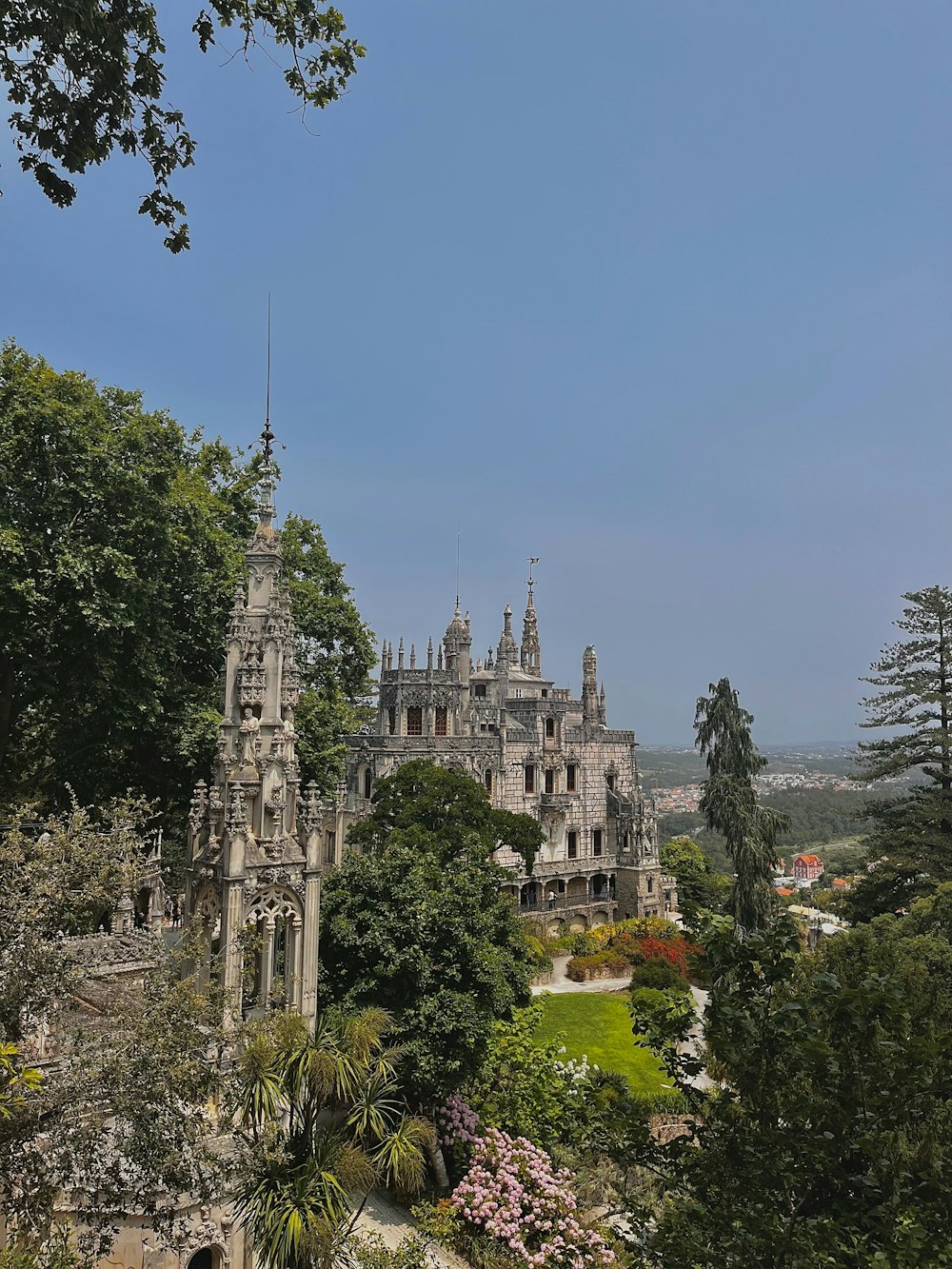 a castle with a clock tower in the middle of a park