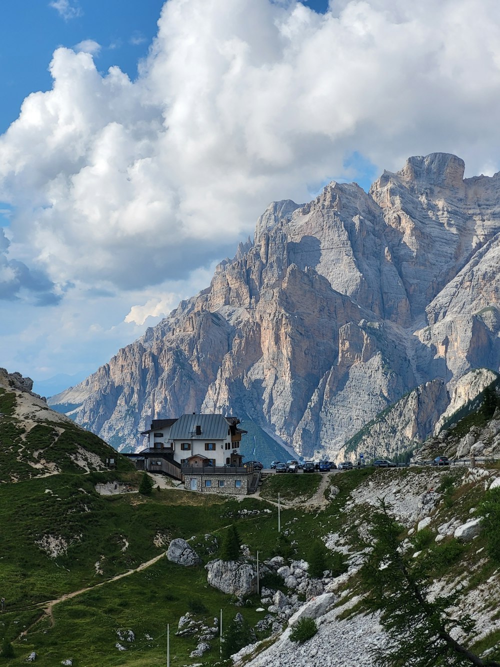 a house in the mountains with a mountain in the background