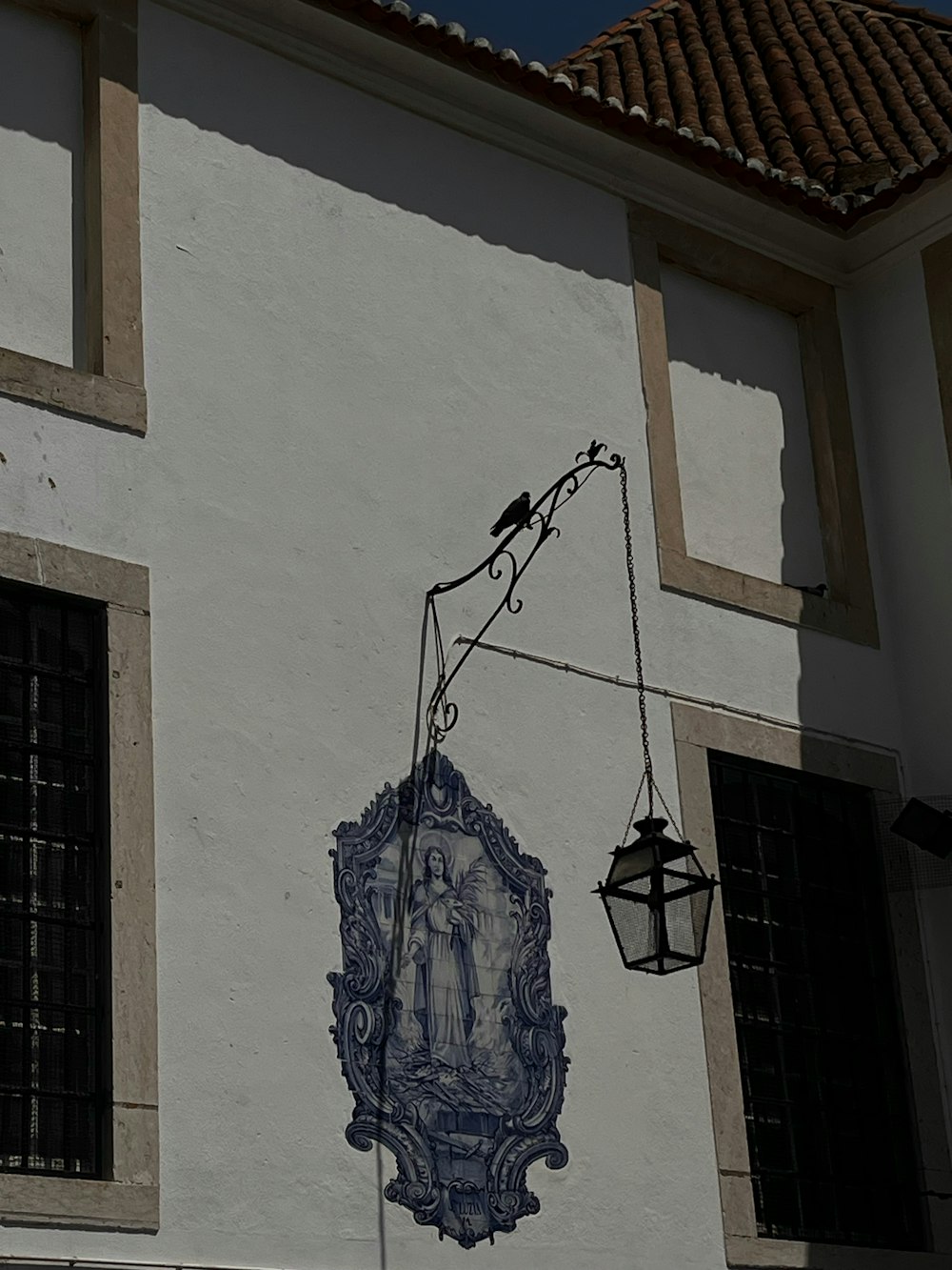 a white building with a clock and a bird on it