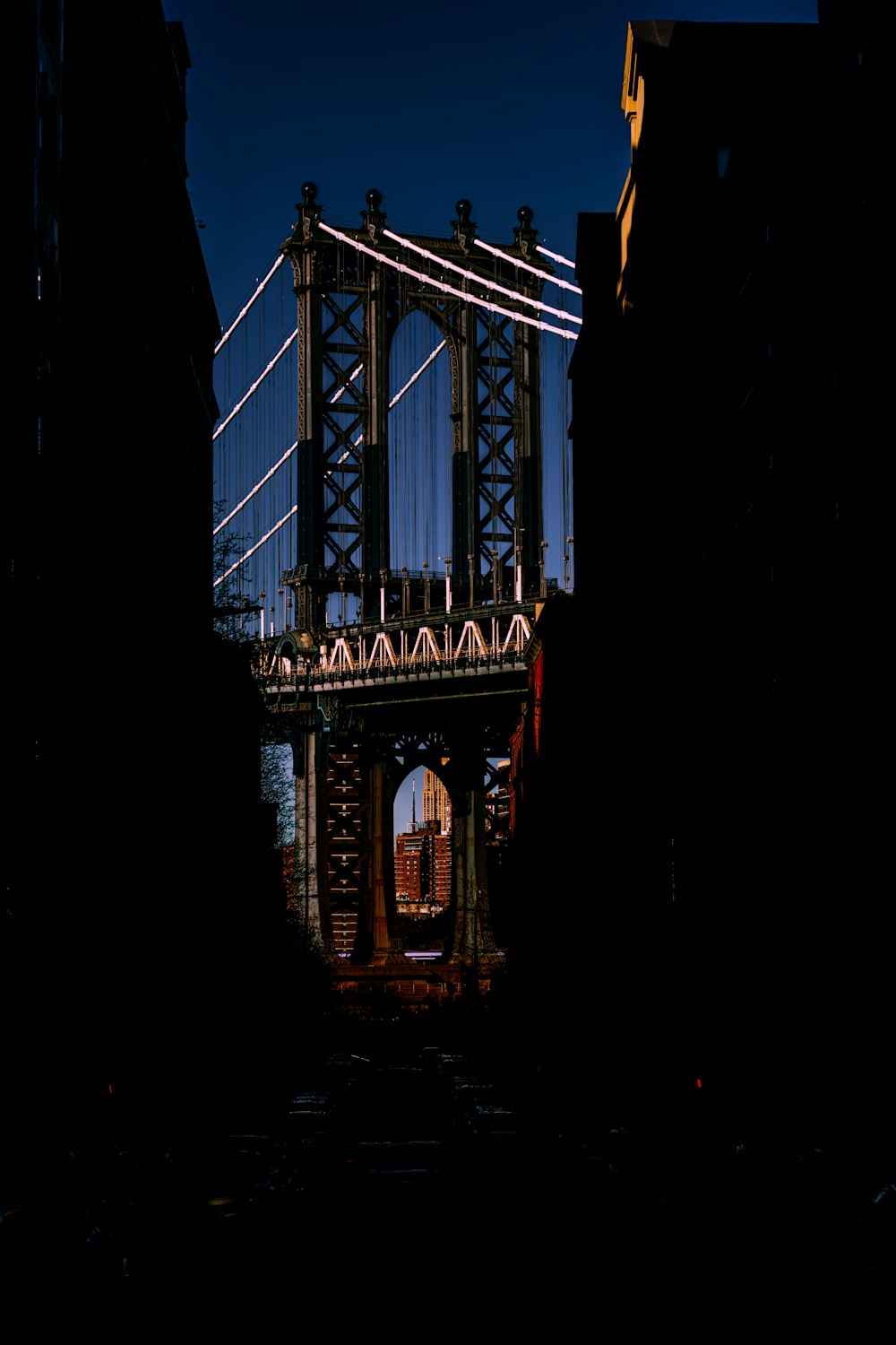 a very tall bridge over a river next to tall buildings