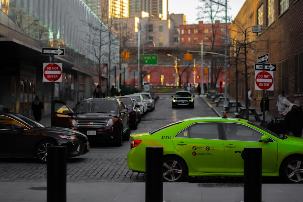 a green car parked on the side of a road