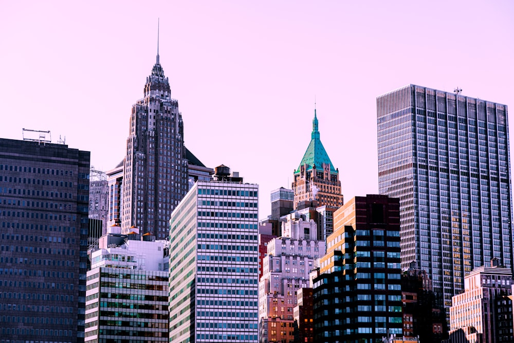 a city skyline with tall buildings and a clock tower