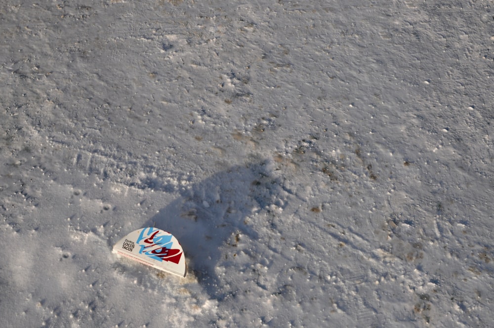 a can of soda sitting in the snow