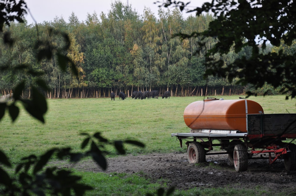 a wagon with a tank on it in a field