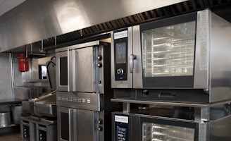 a kitchen filled with lots of stainless steel appliances