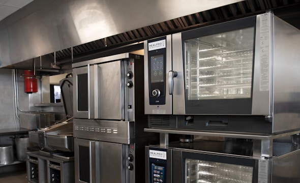 a kitchen filled with lots of stainless steel appliances