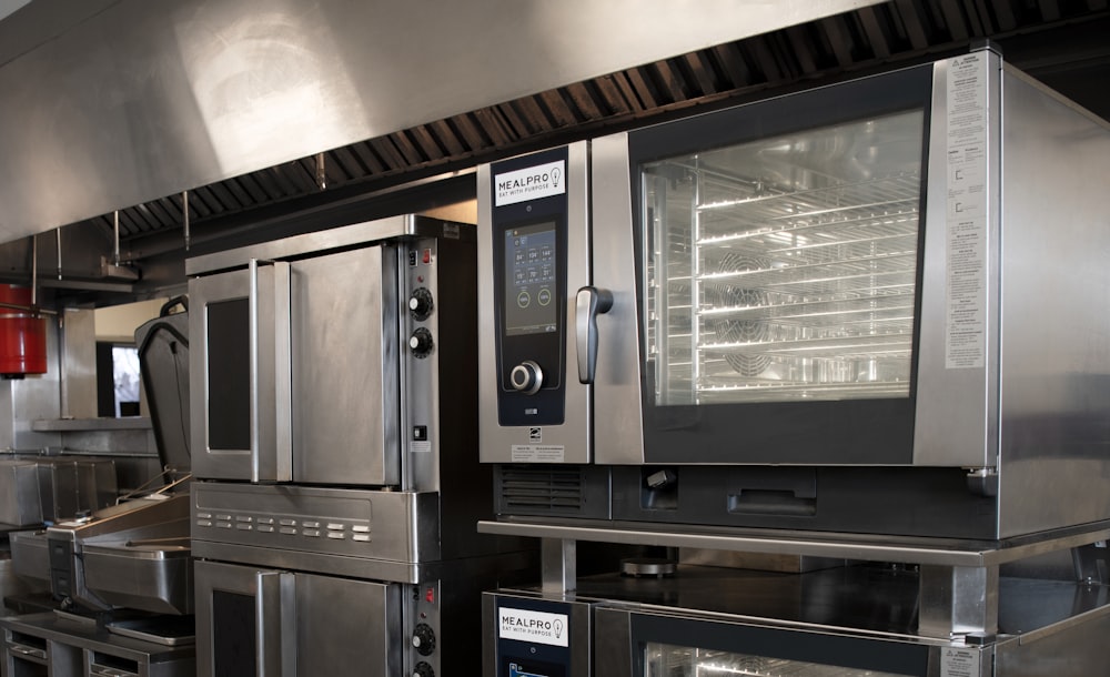 a kitchen filled with lots of stainless steel appliances