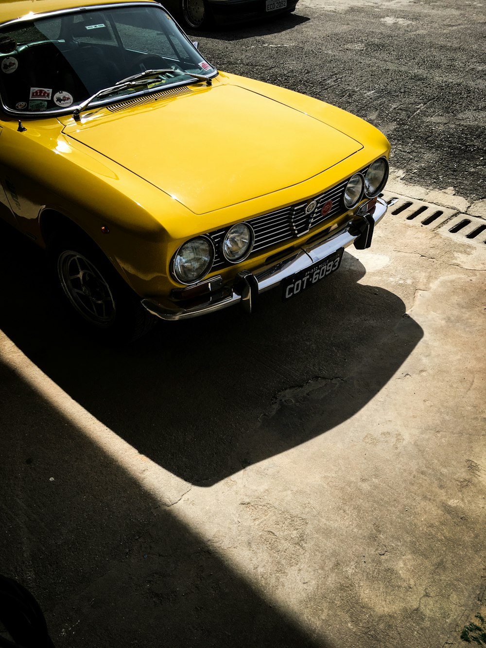 a yellow car parked on the side of the road