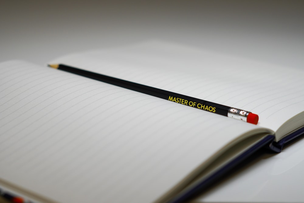 a pencil sitting on top of an open notebook