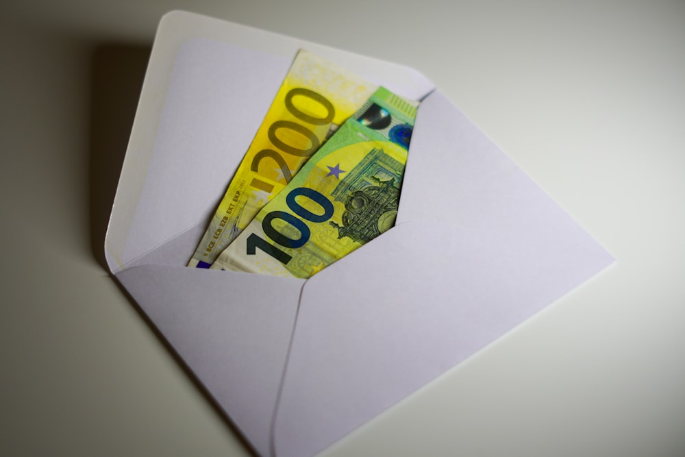 a white envelope with money sticking out of it