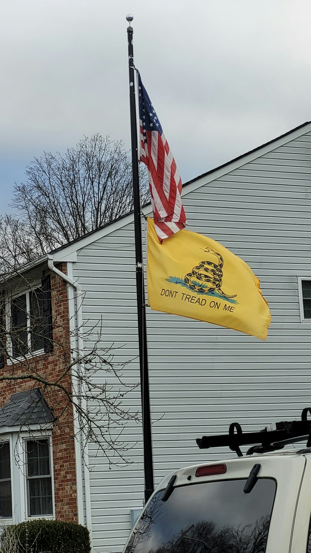Uma bandeira americana e um mastro de bandeira na frente de uma casa