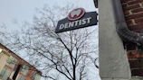 a dentist sign hanging off the side of a building