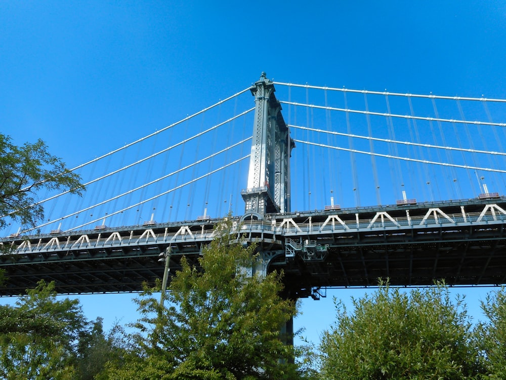 a tall bridge with a clock on the side of it