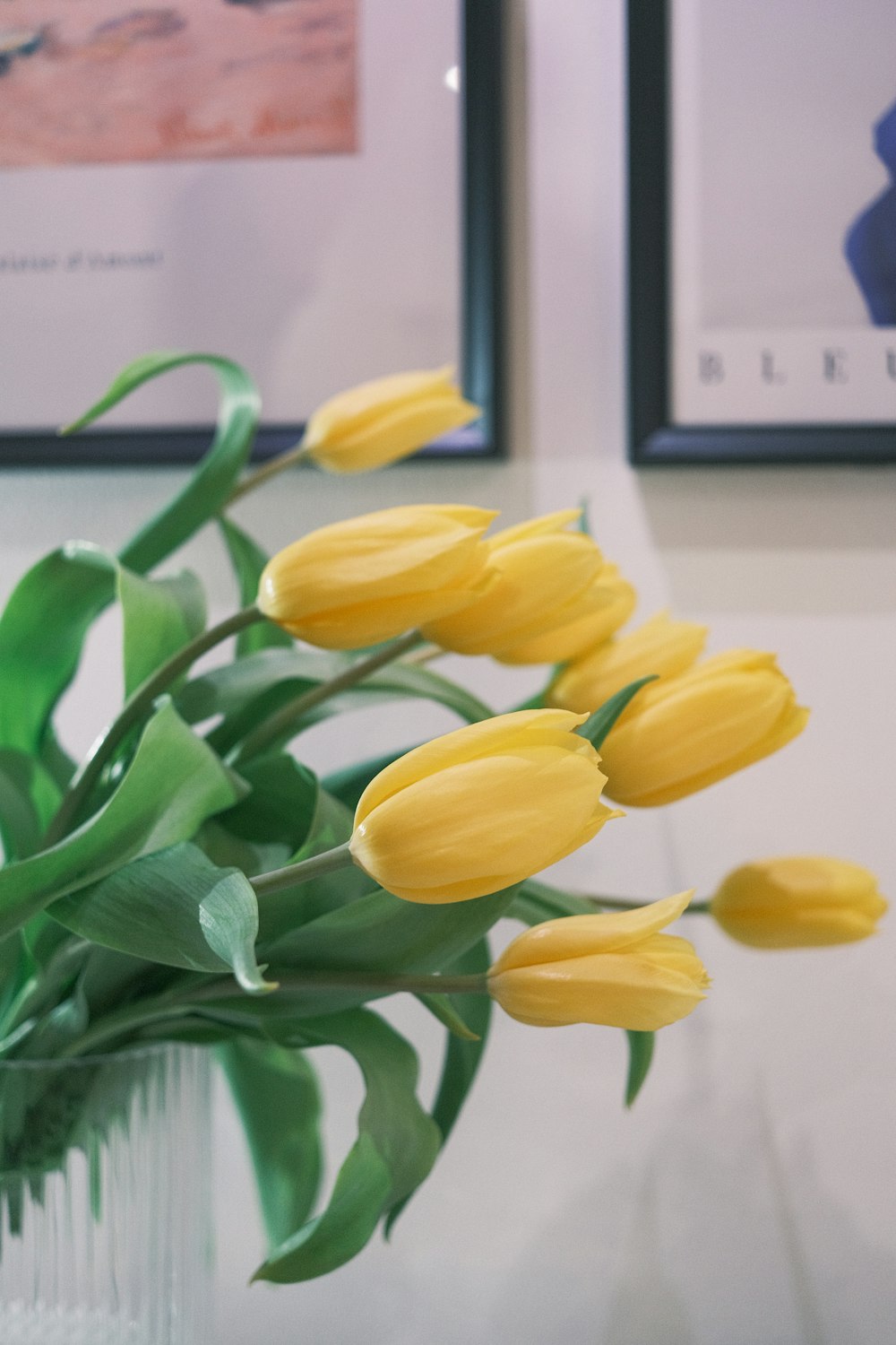 a vase filled with yellow flowers on top of a table