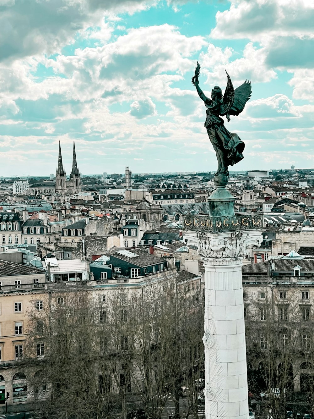 a statue of an angel on top of a building