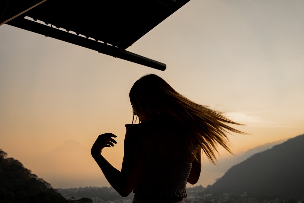 a woman with her hair blowing in the wind