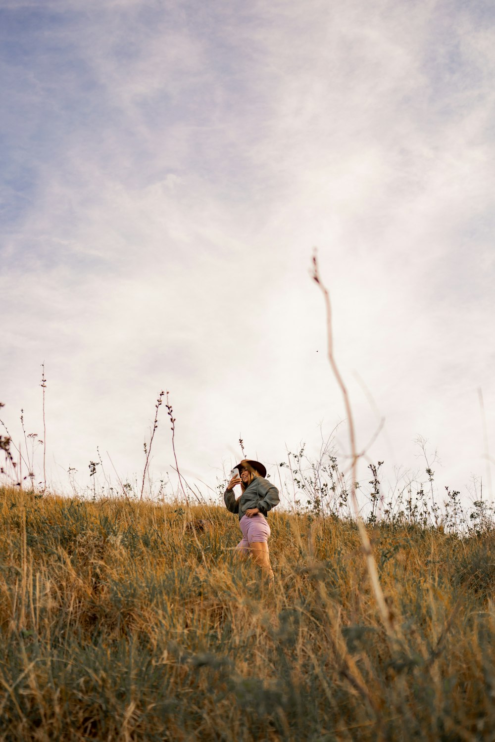 a person standing in a field of tall grass