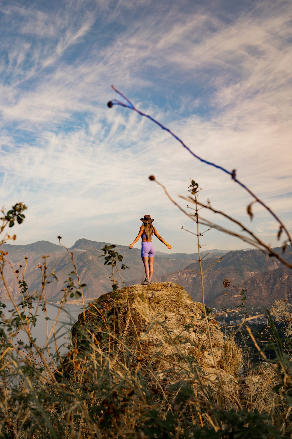 a woman standing on top of a hill