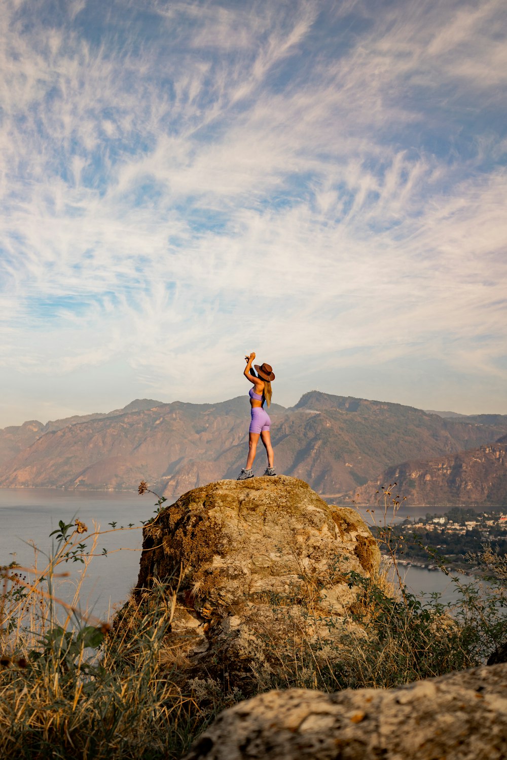 a couple of people standing on top of a rock