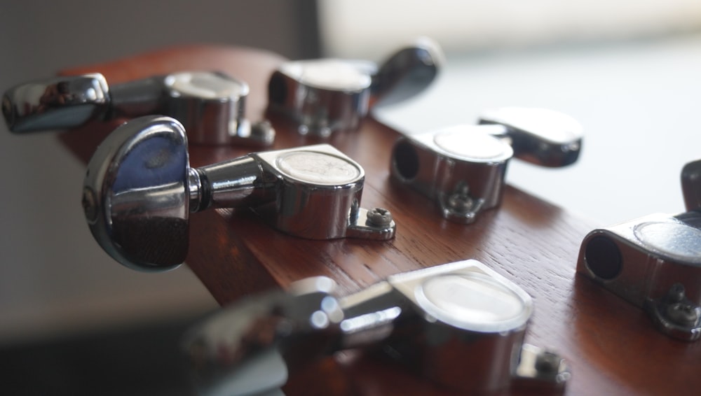 a wooden table topped with lots of metal knobs