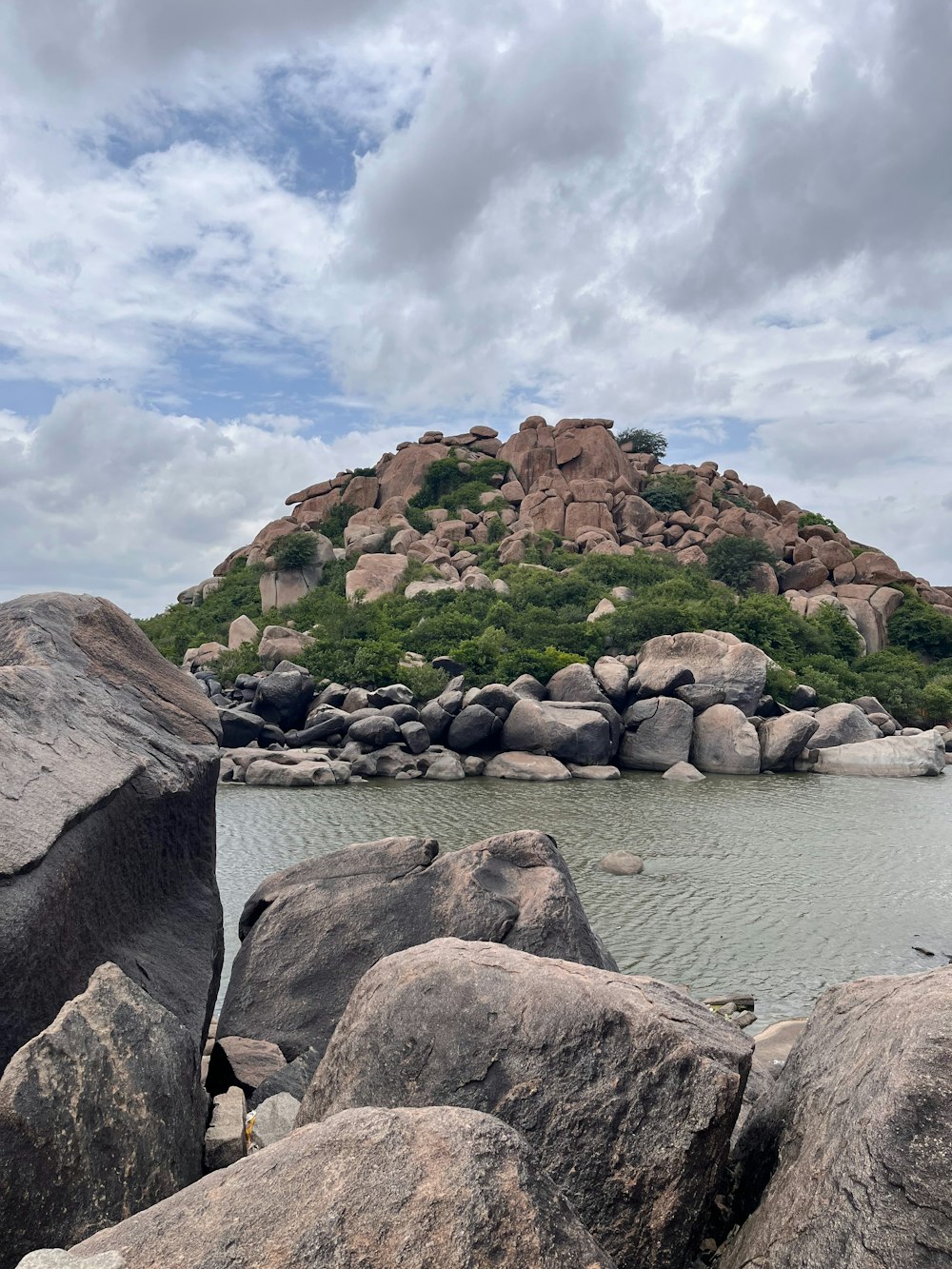 a large rock sitting on top of a body of water