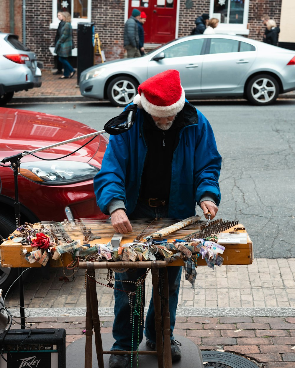 a man in a santa hat is playing a musical instrument