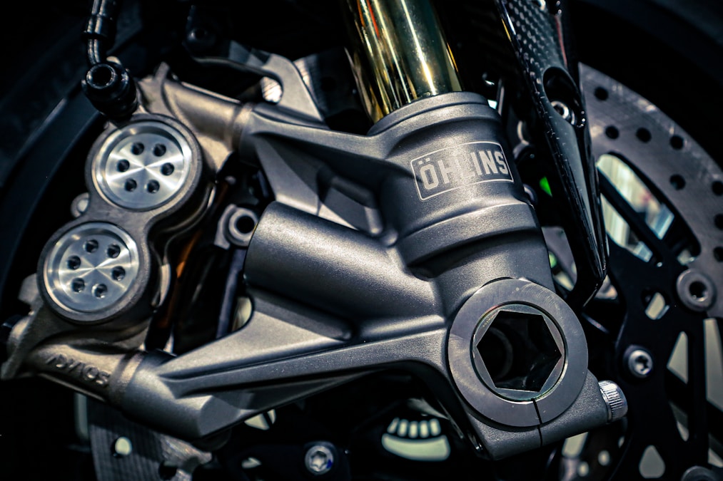 Motorcycle front fork, caliper, and brake rotor close-up
