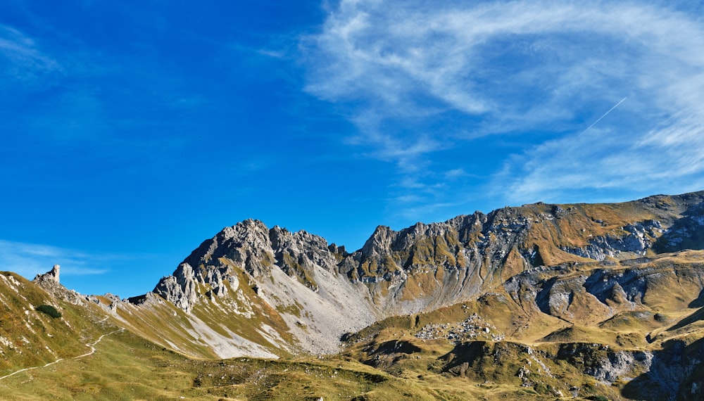a view of a mountain range with a blue sky in the background