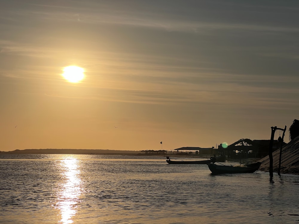 a couple of boats floating on top of a body of water