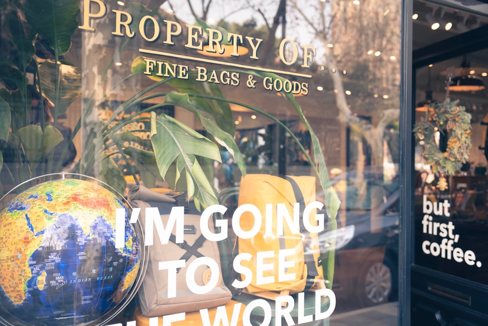 a window display of a coffee shop with a globe in the window