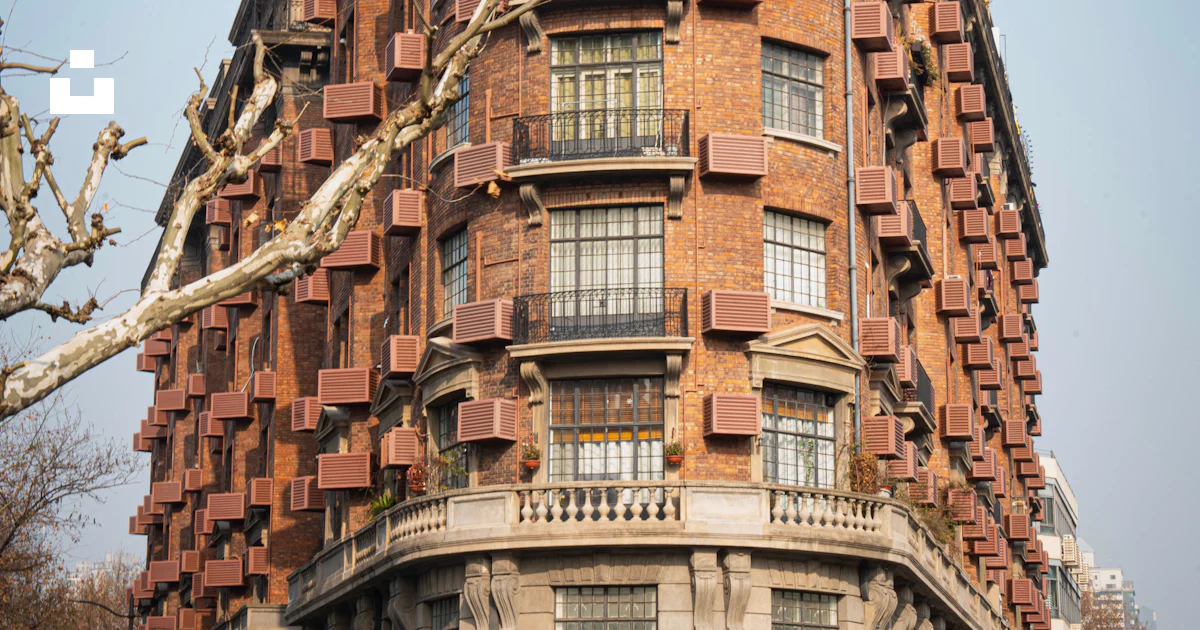 A very tall building with lots of windows and balconies photo – Free ...