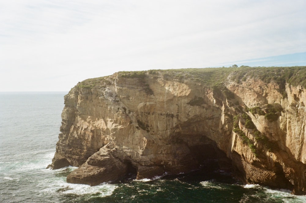 a large cliff with a large body of water