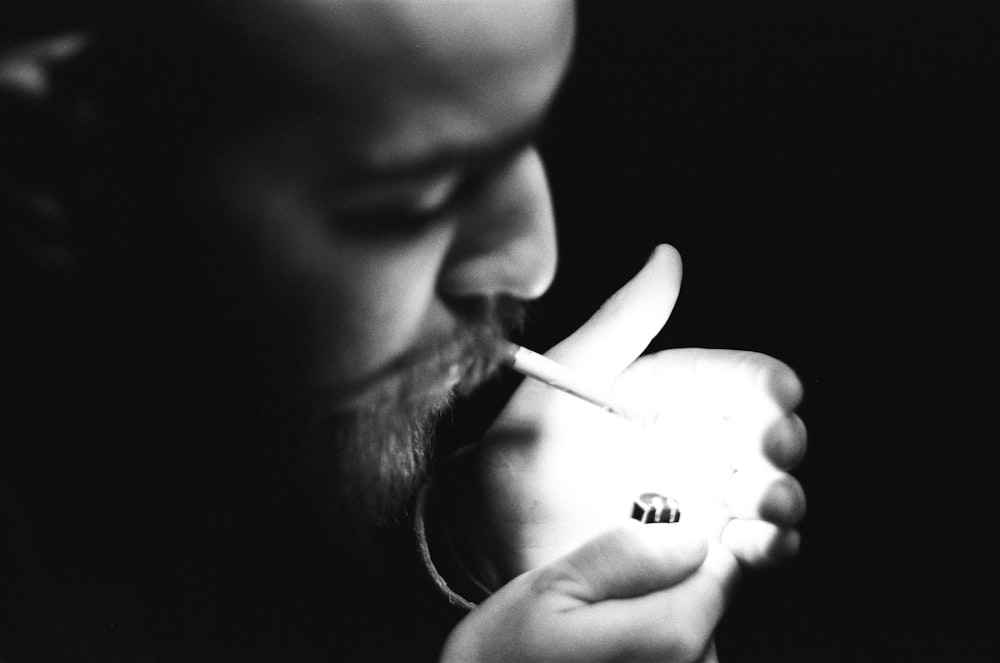 a man holding a banana and smoking a cigarette