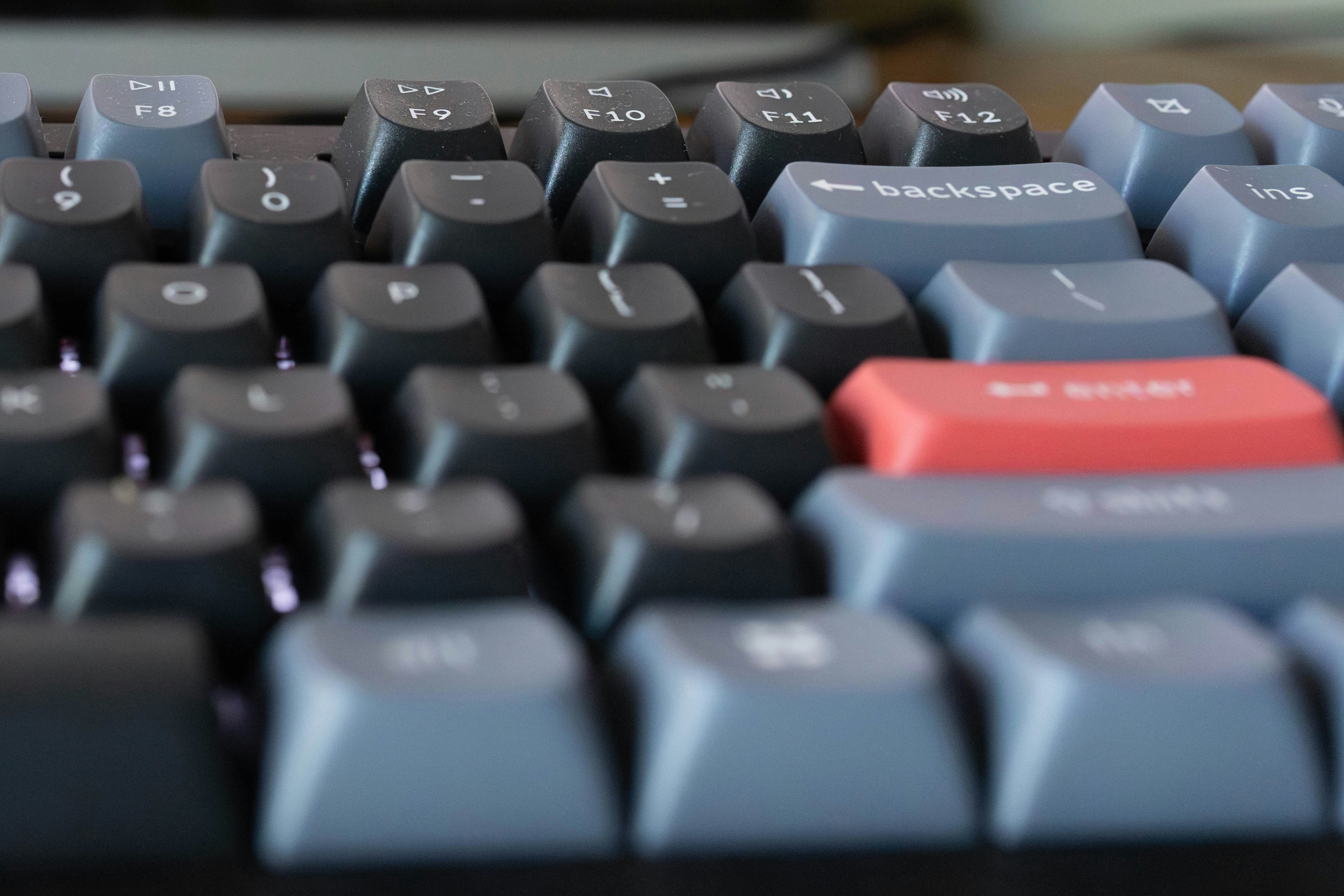 a close up of a keyboard with a red button