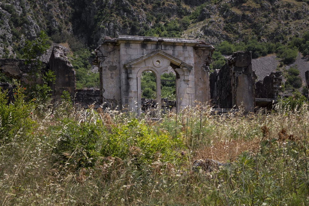 an old building in a field of grass