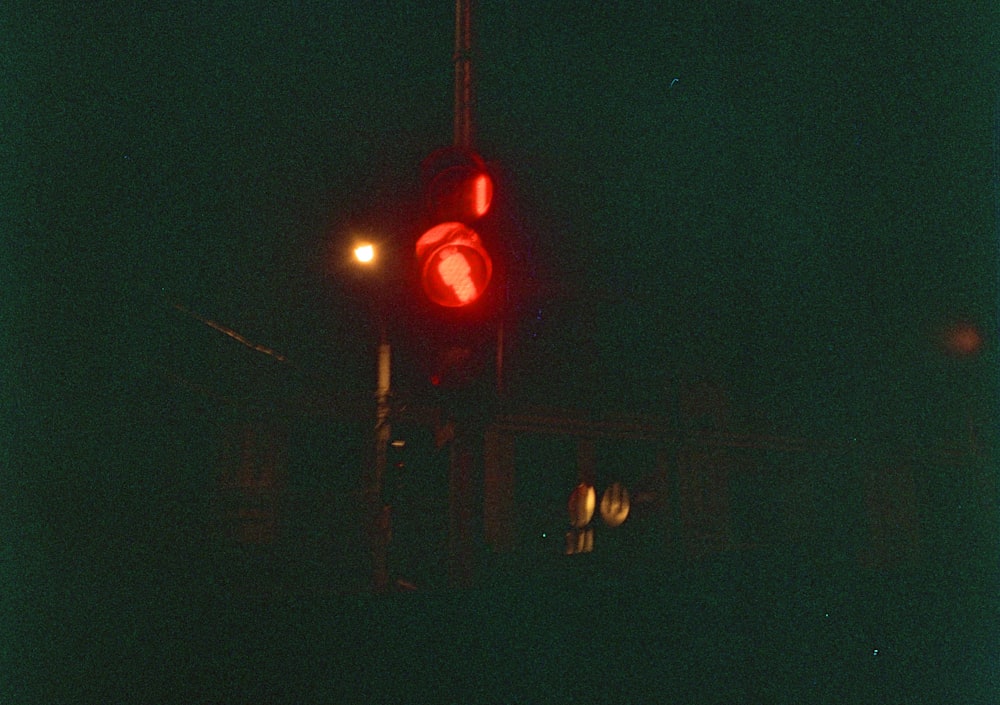 a traffic light with a red light at night