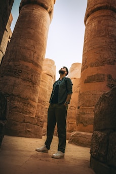a man standing in front of two large pillars