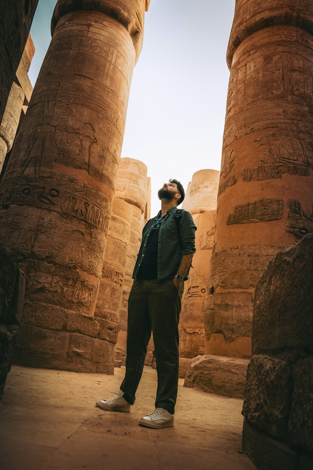 a man standing in front of two large pillars