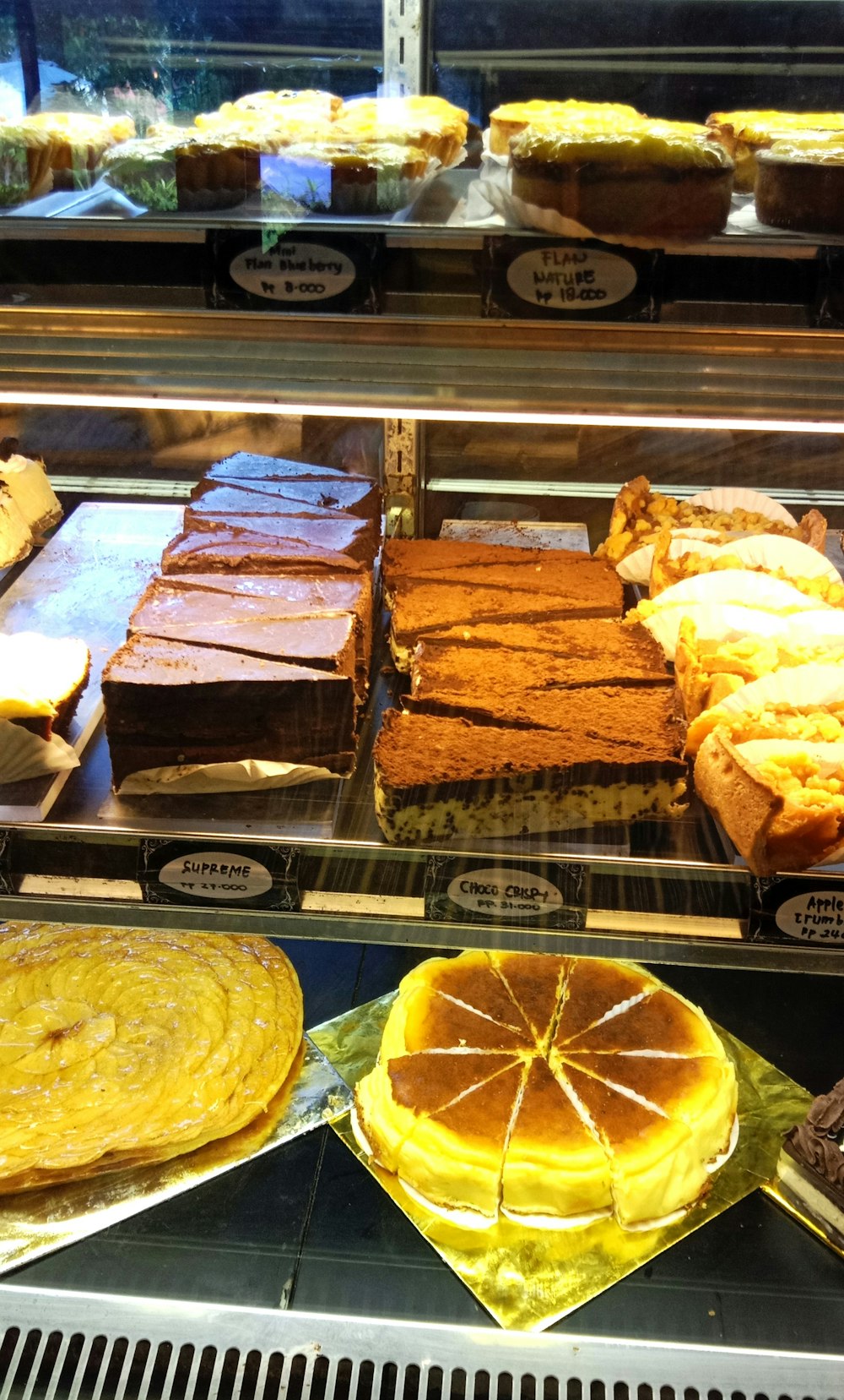 a display case filled with lots of different types of cakes