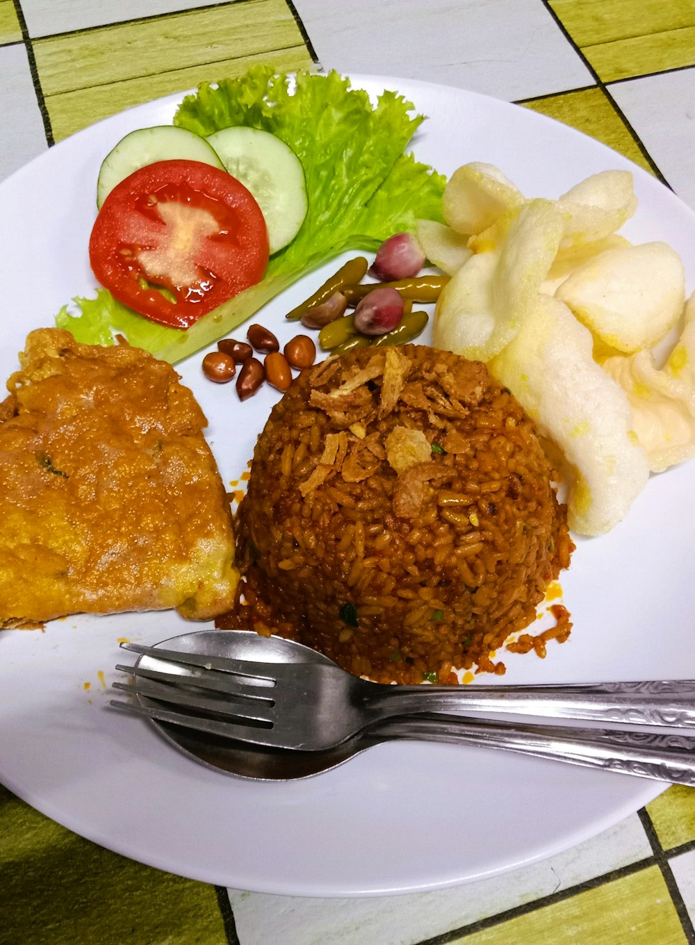 a white plate topped with food and a fork