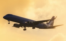 a large jetliner flying through a cloudy sky