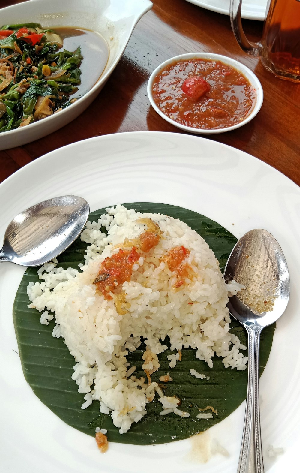a white plate topped with rice and vegetables