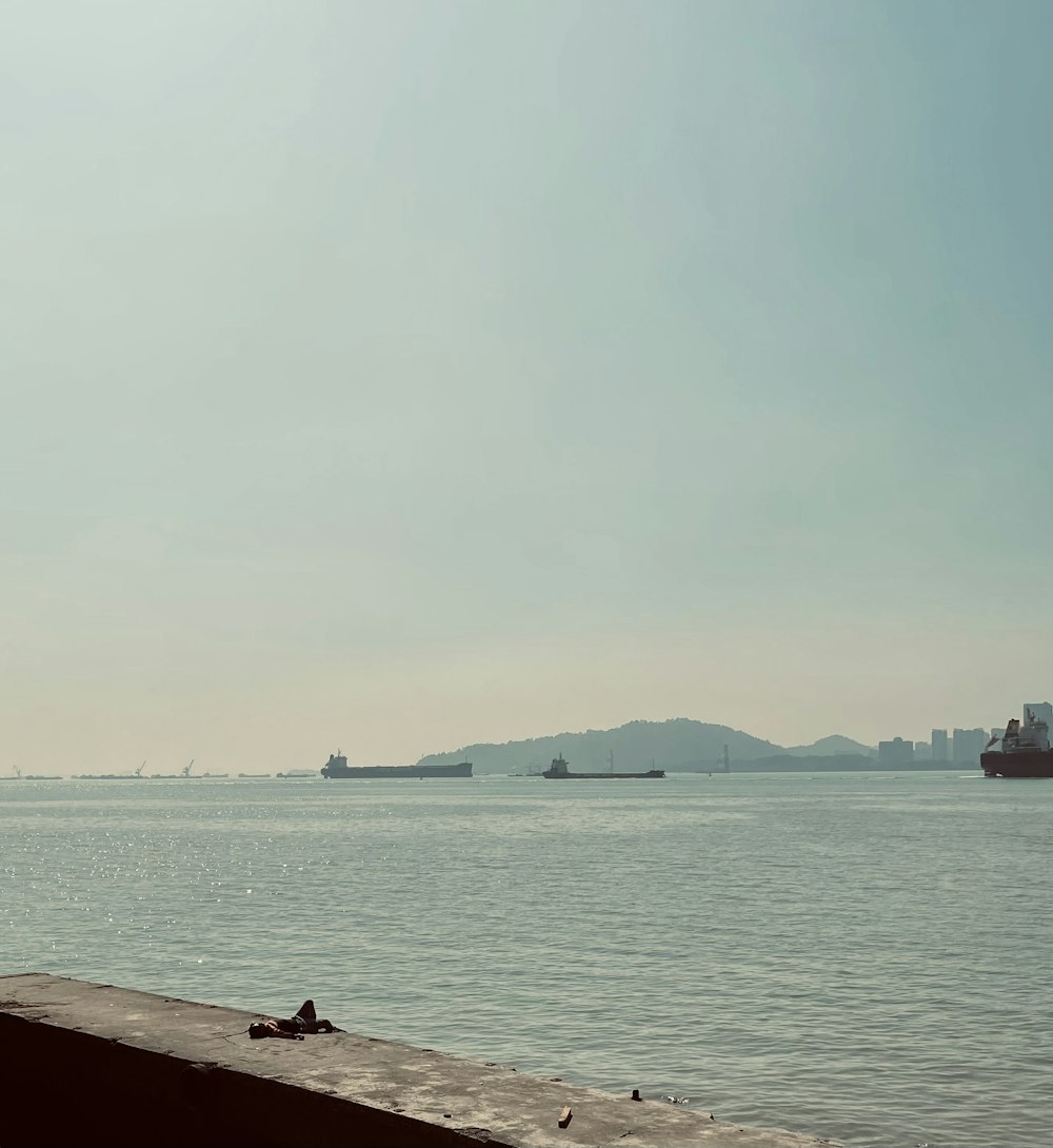 a large body of water with a boat in the distance