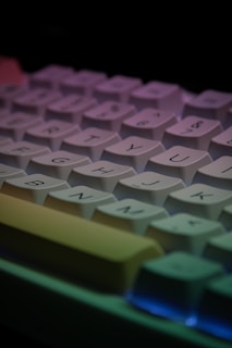 a close up of a computer keyboard with a multicolored key board