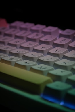 a close up of a computer keyboard with a multicolored key board